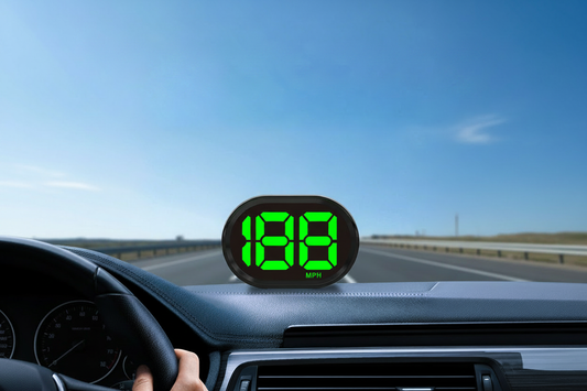 K2 GPS Speedometer mounted on car dashboard, displaying bright green digital speed in MPH, with open highway and blue sky in the background — K2 GPS Speedometer Installation Guide
